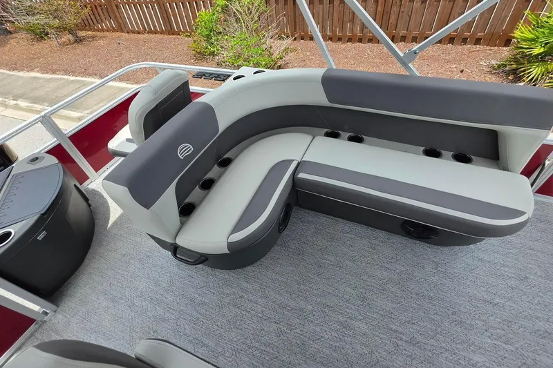 Slide: The Image of 2026 Sun Tracker Bass Buggy 18 DLX pontoon boat with comfortable seating and cup holders. - 17