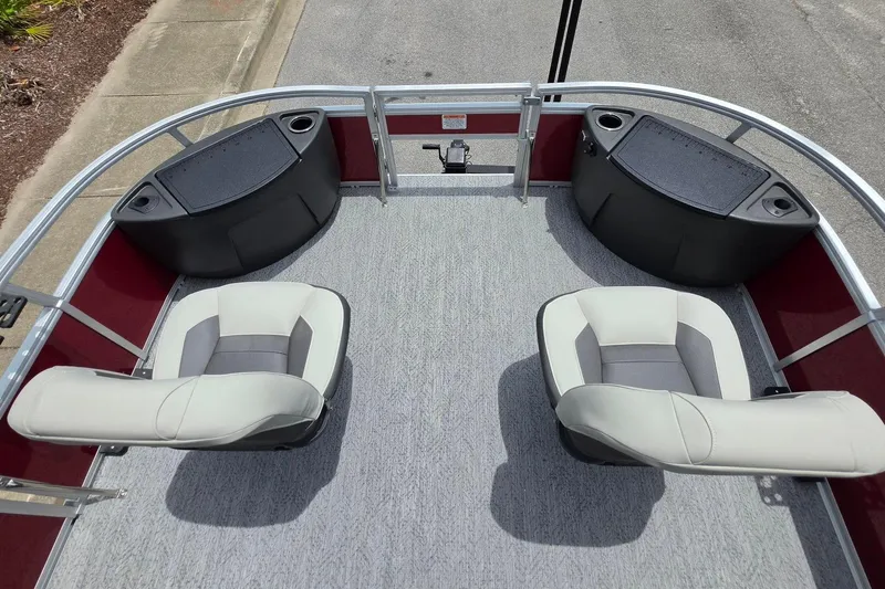 Slide: The Image of 2026 Sun Tracker Bass Buggy 18 DLX pontoon boat interior with seating and storage compartments. - 18