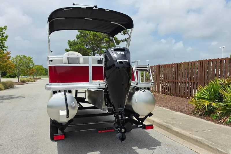 Slide: The Image of 2026 Sun Tracker Bass Buggy 18 DLX pontoon boat with Mercury 75 engine on trailer. - 12