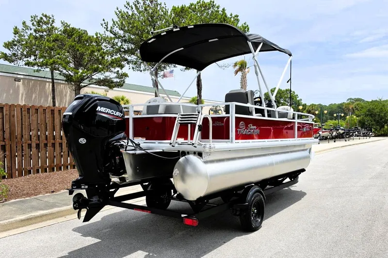 Slide: The Image of 2026 Sun Tracker Bass Buggy 18 DLX pontoon boat with Mercury engine on trailer. - 3
