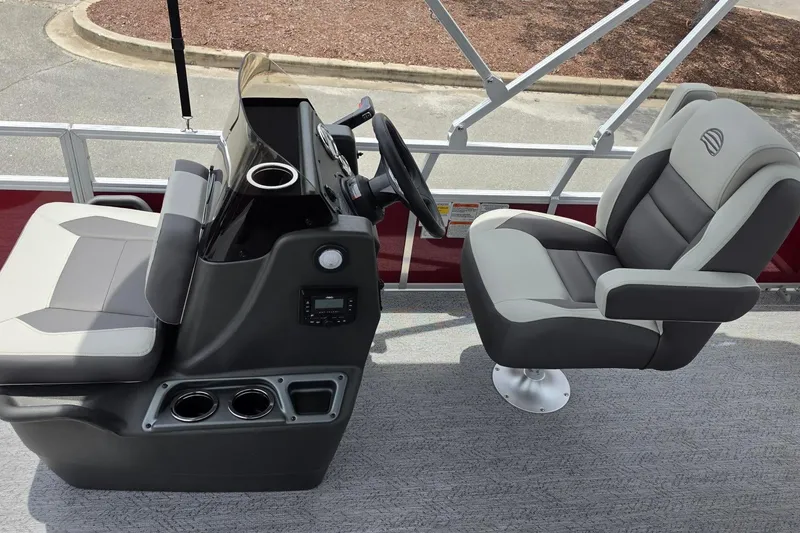 Slide: The Image of 2026 Sun Tracker Bass Buggy 18 DLX boat interior with steering console and seating. - 13