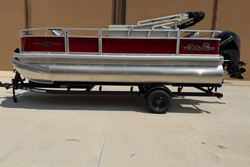 The Image of 2026 Sun Tracker Bass Buggy 18 DLX pontoon boat on trailer, side view. - 0