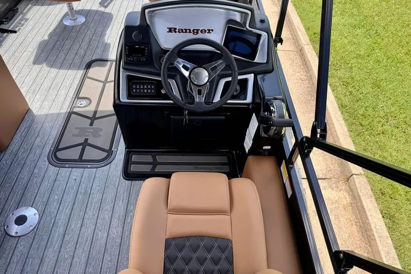 Slide: The Image of 2026 Ranger 223F boat cockpit with steering wheel and tan seating. - 20