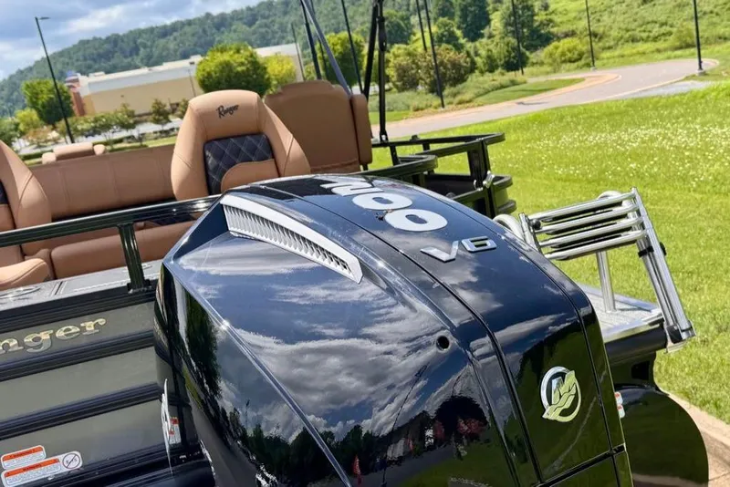 Slide: The Image of 2026 Ranger 223F boat with powerful V6 engine, parked on lush green grass. - 8