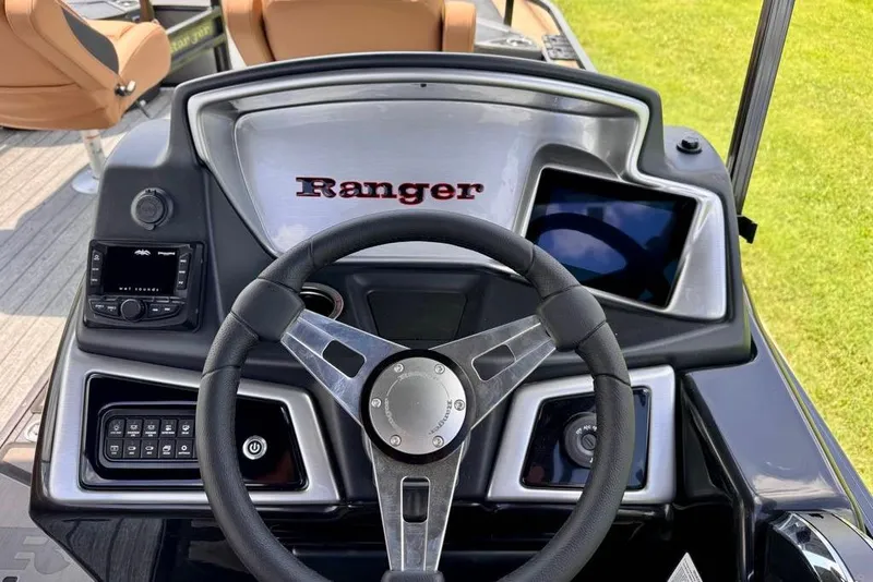 Slide: The Image of 2026 Ranger 223F boat dashboard with steering wheel and control panel. - 18