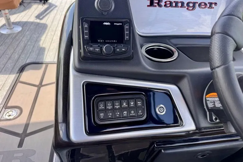 Slide: The Image of Control panel of 2026 Ranger 223F boat with audio system and power button. - 21