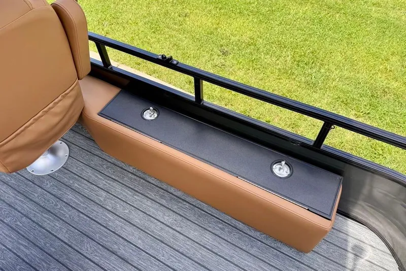 Slide: The Image of 2026 Ranger 223F boat interior with tan seating and black storage compartment on gray deck. - 22