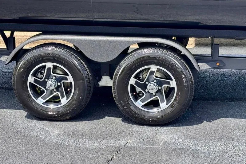 Slide: The Image of 2026 Ranger 223F trailer wheels on asphalt, showcasing sleek design and durable tires. - 7