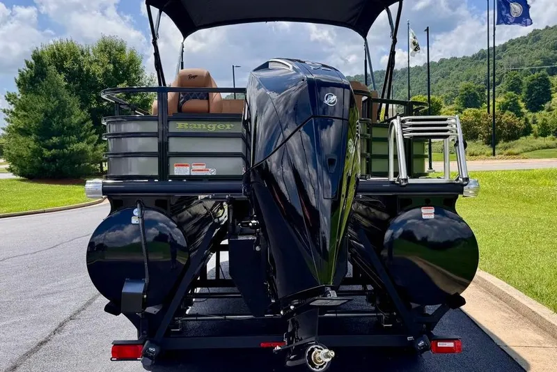 Slide: The Image of 2026 Ranger 223F boat with powerful outboard motor, parked on a scenic road. - 6