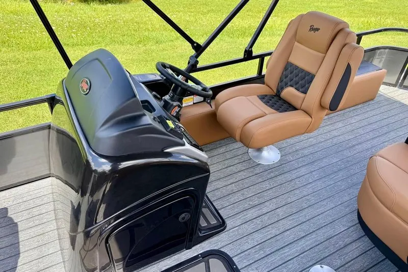 Slide: The Image of 2026 Ranger 223F boat interior with tan leather seating and sleek black console. - 14