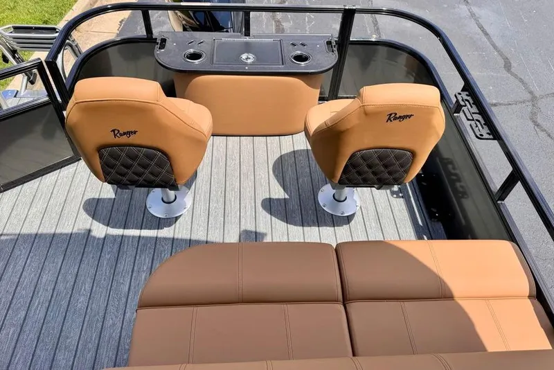 Slide: The Image of 2026 Ranger 223F boat interior with tan seats and black accents, featuring a sleek design. - 13