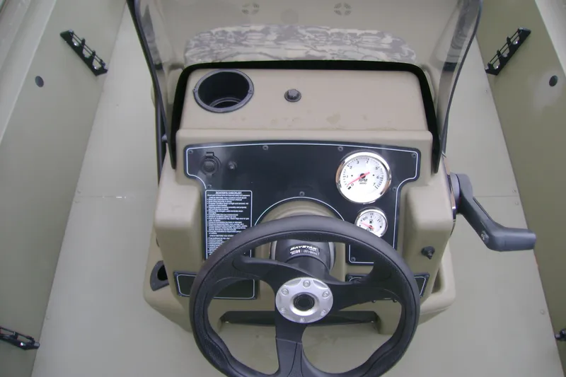 Slide: The Image of 2026 Tracker Grizzly 1860 CC boat console with steering wheel and gauges. - 10