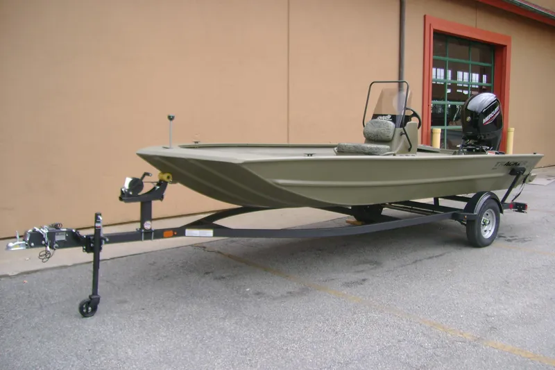 Slide: The Image of 2026 Tracker Grizzly 1860 CC boat on trailer, parked outdoors. - 3