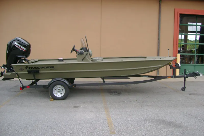 The Image of 2026 Tracker Grizzly 1860 CC boat on trailer, parked outdoors. - 0