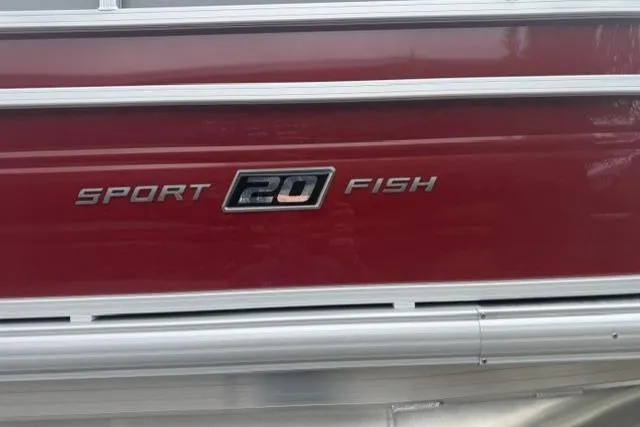Slide: The Image of 2026 Sun Tracker SportFish 20 DLX boat, red exterior with silver accents. - 2