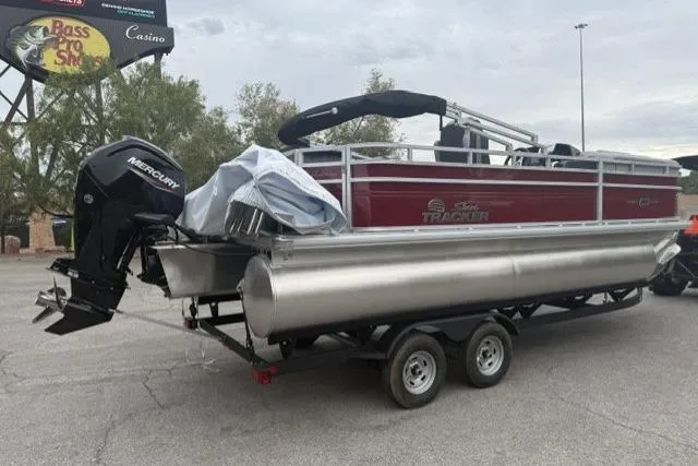 Slide: The Image of 2026 Sun Tracker SportFish 20 DLX pontoon boat on trailer, featuring Mercury outboard motor. - 3