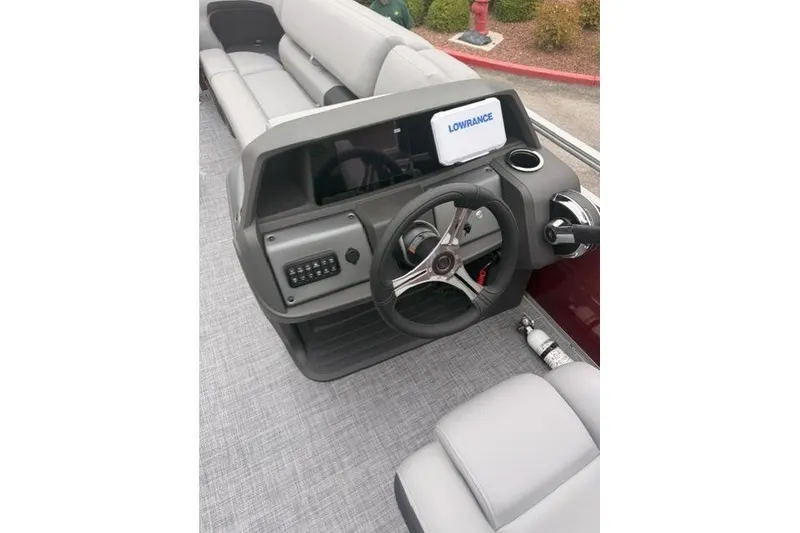 Slide: The Image of 2026 Sun Tracker SportFish 20 DLX boat dashboard with steering wheel and Lowrance display. - 5