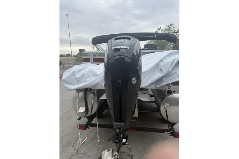 Slide: The Image of 2026 Sun Tracker SportFish 20 DLX boat with covered seating and outboard motor. - 4