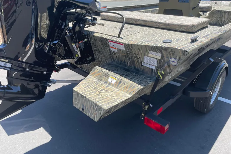 Slide: The Image of 2026 Tracker Grizzly 1860 CC boat with camouflage design and outboard motor. - 17