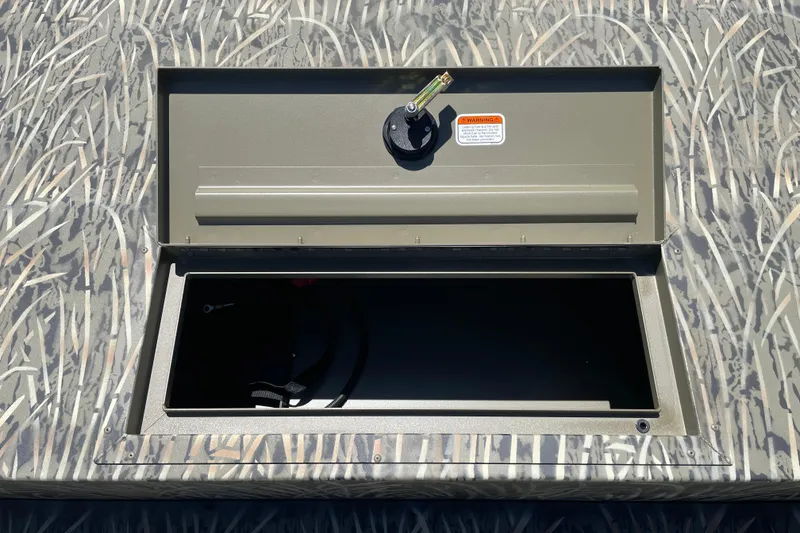Slide: The Image of Open storage compartment on 2026 Tracker Grizzly 1860 CC boat with camouflage pattern. - 8