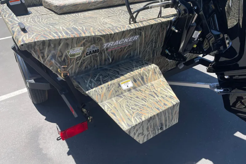Slide: The Image of 2026 Tracker Grizzly 1860 CC boat with camo design and motor mount. - 16