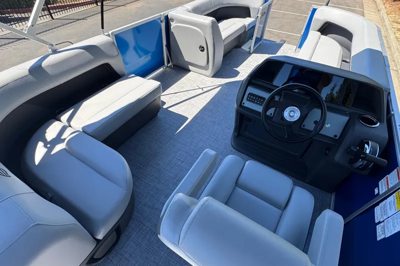 Slide: The Image of 2026 Sun Tracker Party Barge 18 DLX interior with spacious seating and modern helm. - 17
