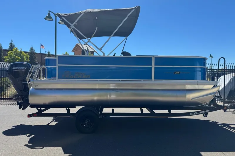 Slide: The Image of 2026 Sun Tracker Party Barge 18 DLX pontoon boat with Mercury engine on trailer. - 9