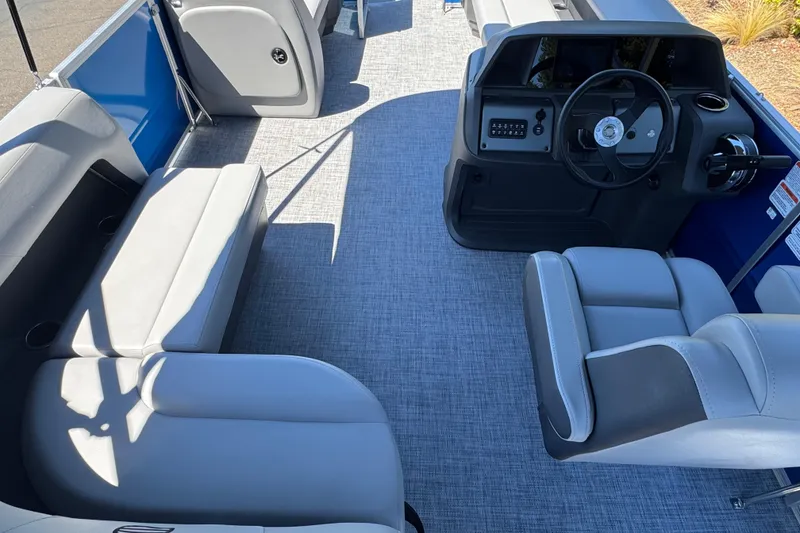 Slide: The Image of 2026 Sun Tracker Party Barge 18 DLX interior with seating and steering console. - 14