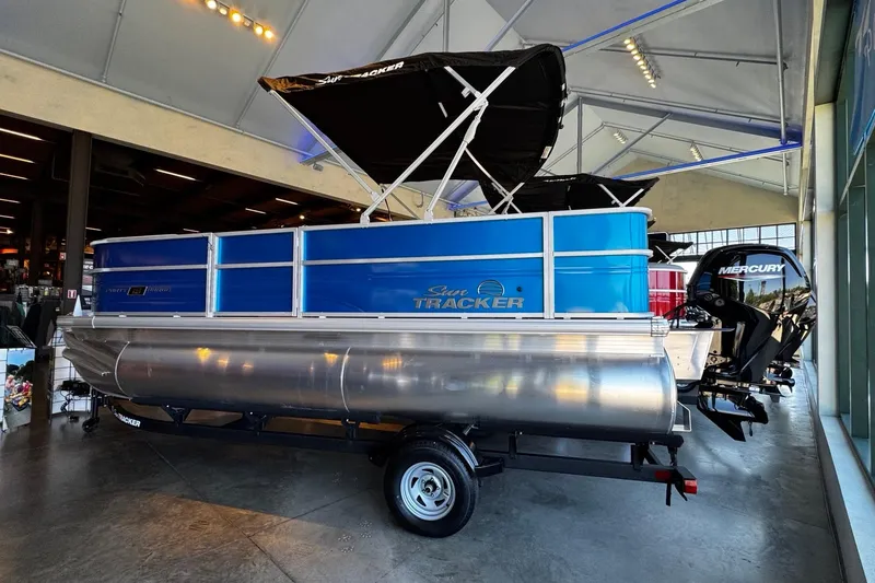 Slide: The Image of 2026 Sun Tracker Party Barge 18 DLX pontoon boat displayed indoors. - 11