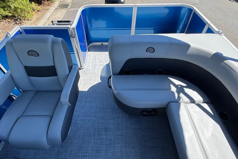 Slide: The Image of 2026 Sun Tracker Party Barge 18 DLX interior with gray seating and blue accents. - 12