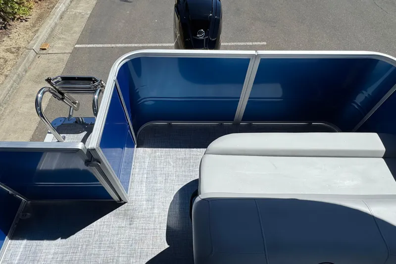 Slide: The Image of 2026 Sun Tracker Party Barge 18 DLX interior with blue panels and seating. - 13