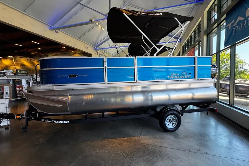 The Image of 2026 Sun Tracker Party Barge 18 DLX pontoon boat displayed indoors. - 0