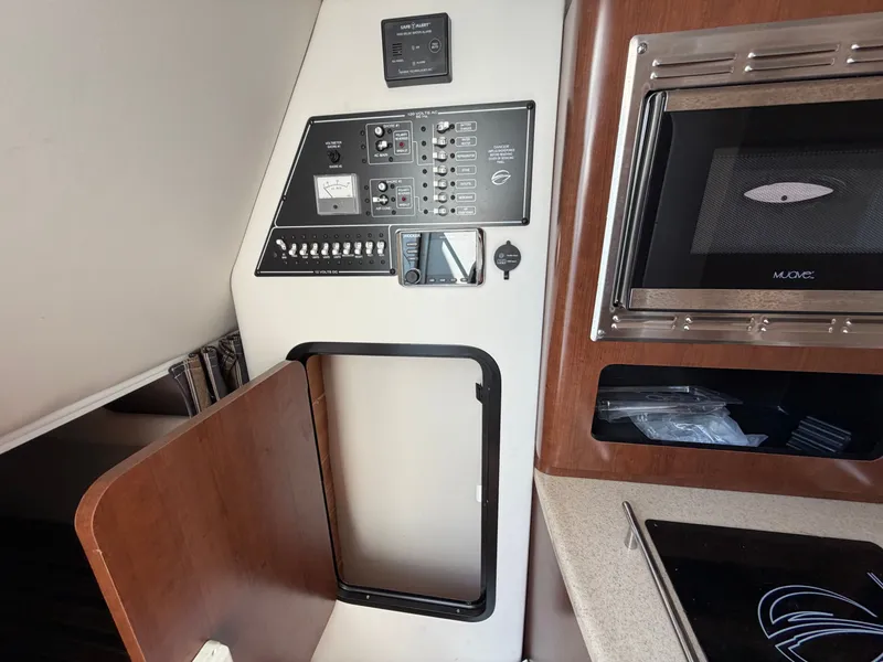 Slide: The Image of Interior of a 2018 Crownline 264 CR with control panel and microwave. - 11