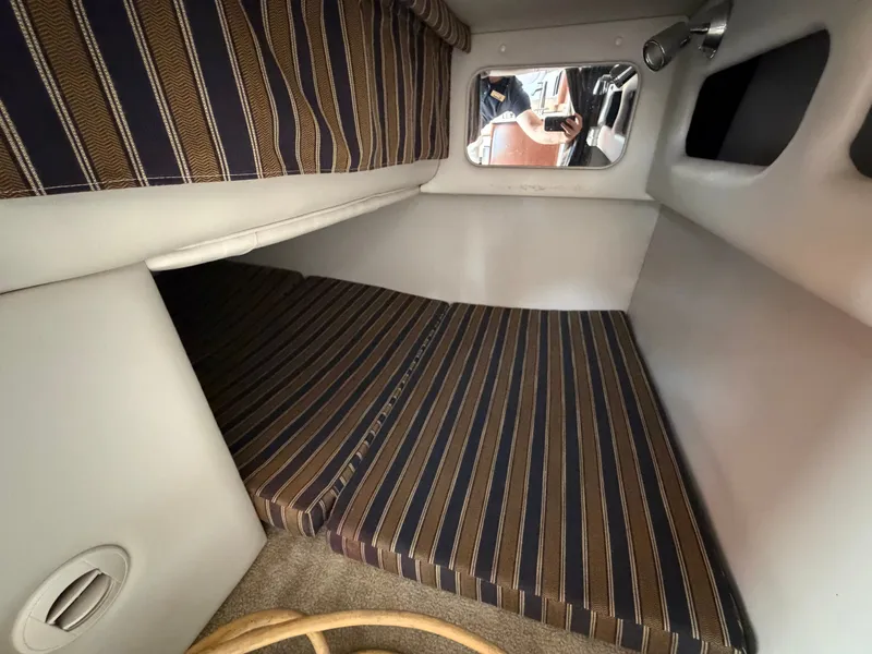Slide: The Image of Interior of the 2018 Crownline 264 CR with striped upholstery. - 12