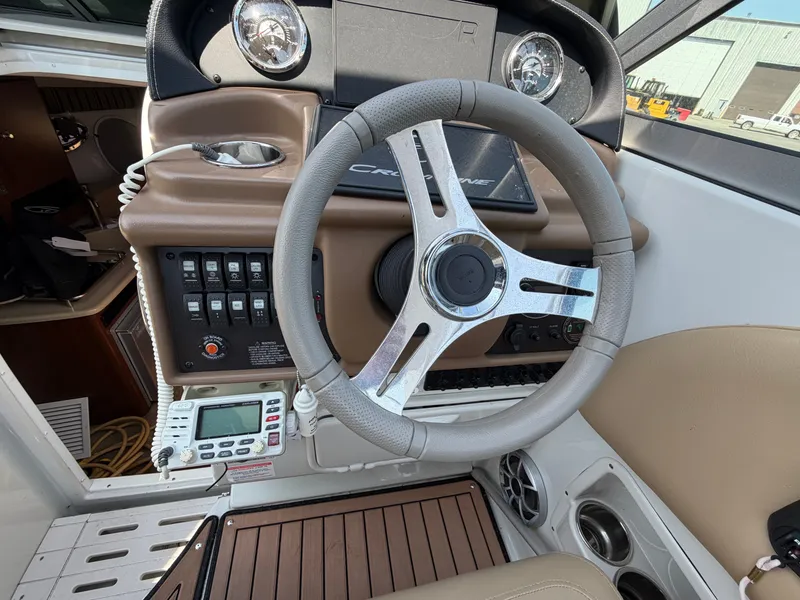 Slide: The Image of The image shows the helm of a 2018 Crownline 264 CR boat with modern instruments. - 7