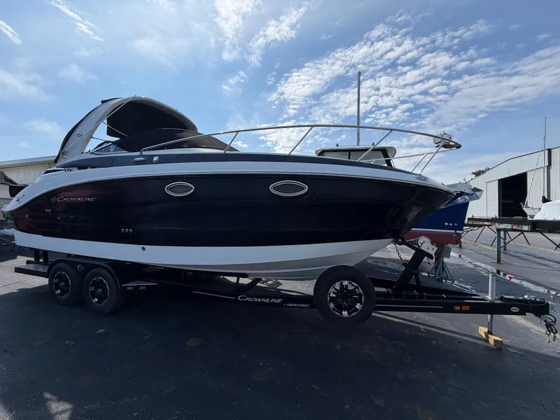 The Image of A 2018 Crownline 264 CR boat on a trailer, ready for the water. - 0