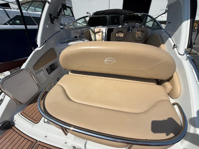 Slide: The Image of The image shows the cockpit of a 2018 Crownline 264 CR boat with beige seating. - 2