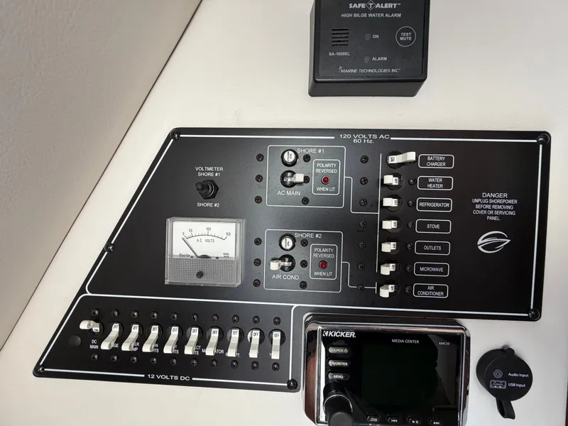 Slide: The Image of The image shows the control panel of a Crownline 264 CR boat with various switches and gauges. - 10
