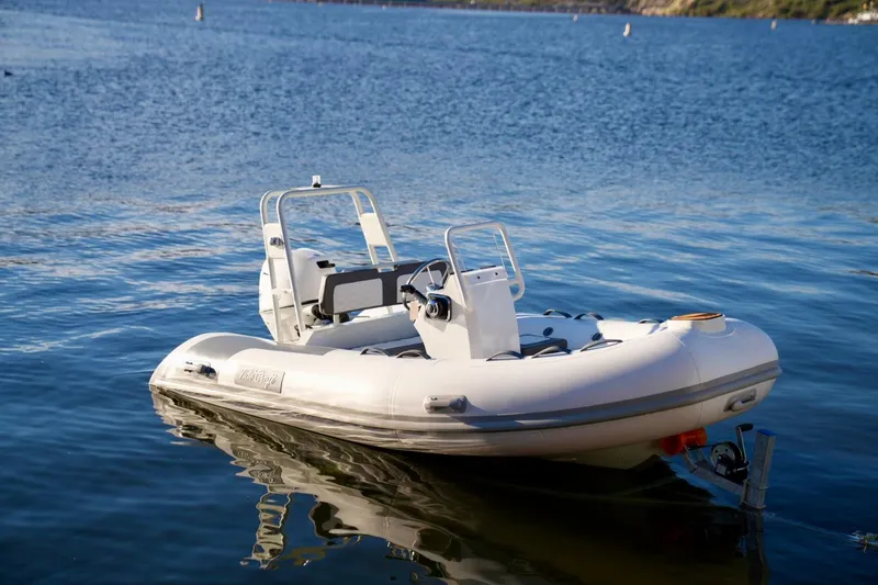 Slide: The Image of 2027 Tide Craft San Juan 11 Hypalon boat floating on calm water. - 13