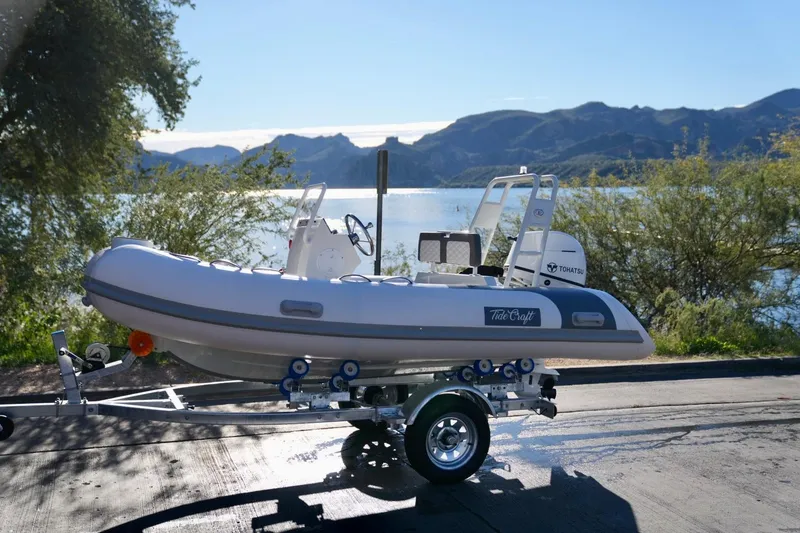 Slide: The Image of 2027 Tide Craft San Juan 11 Hypalon boat on trailer by scenic lake. - 14