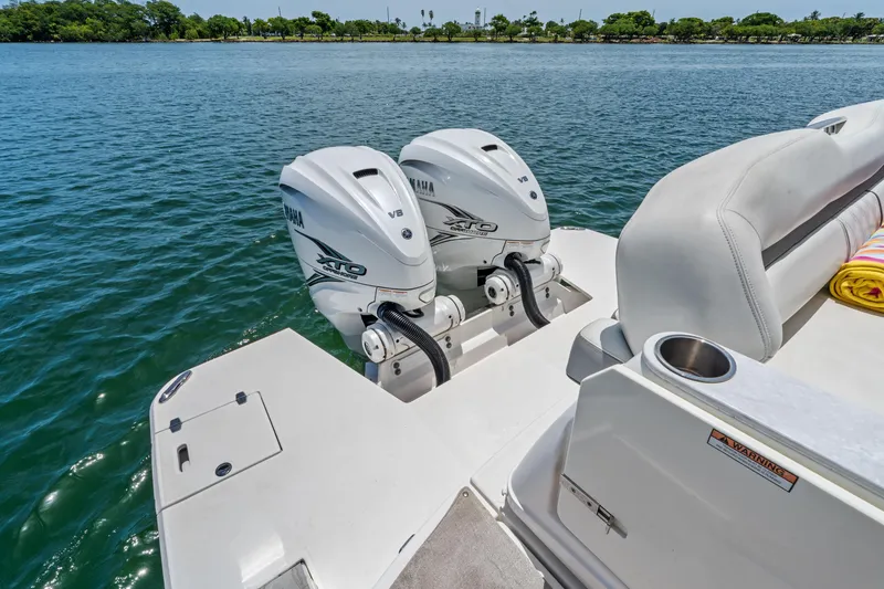 Slide: The Image of 2022 Regal boat with twin Yamaha XTO V8 outboard engines on a calm lake. - 35