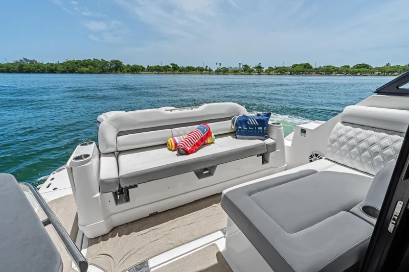 Slide: The Image of Luxurious 2022 Regal boat interior with comfortable seating, cruising on a scenic waterway. - 17