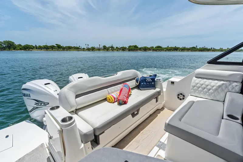 Slide: The Image of Luxurious 2022 Regal boat interior with Yamaha engines, featuring comfortable seating and scenic water view. - 18