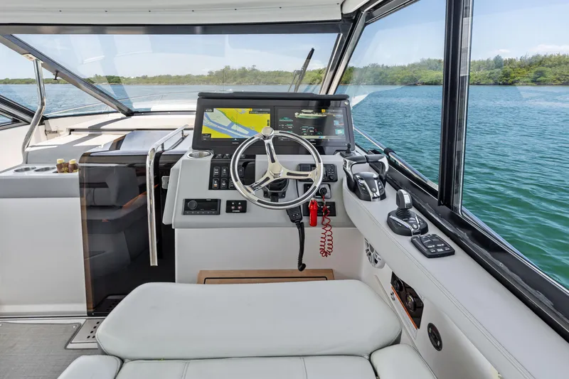 Slide: The Image of Cockpit of a 2022 Regal boat with modern navigation equipment and scenic water view. - 9