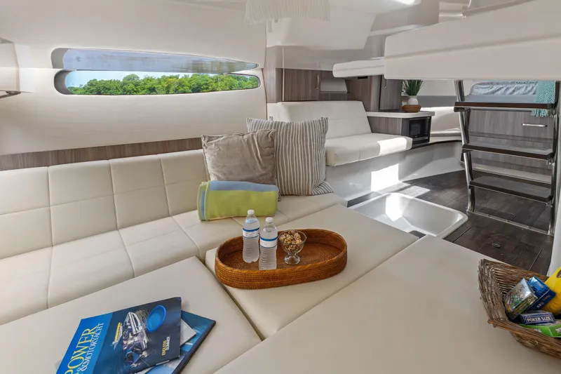 Slide: The Image of Luxurious 2022 Regal yacht interior with plush seating, modern decor, and scenic window view. - 26