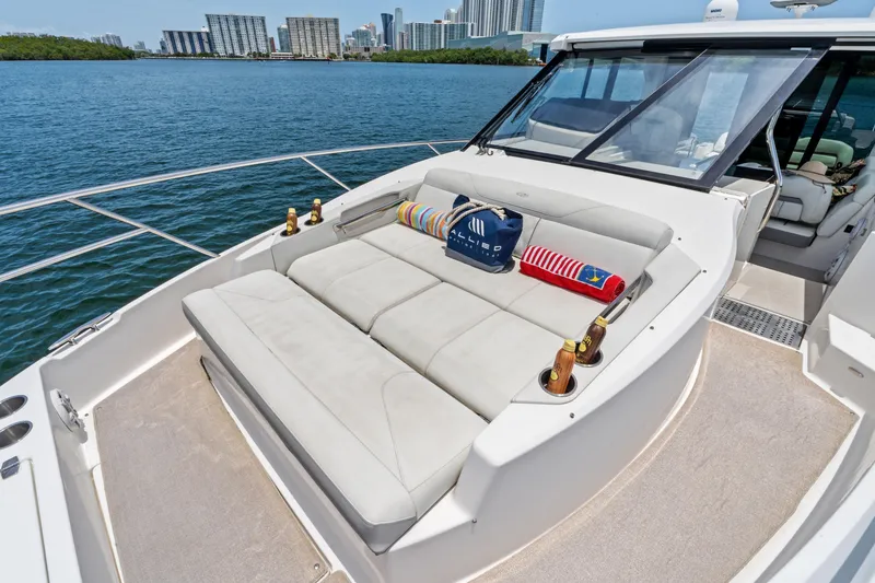 Slide: The Image of Luxurious 2022 Regal yacht with sunbathing deck, city skyline in background. - 5