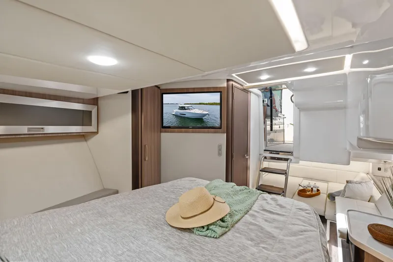 Slide: The Image of Luxurious 2022 Regal boat cabin interior with bed, TV, and modern decor. - 30