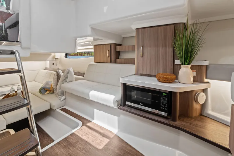 Slide: The Image of Luxurious 2022 Regal boat interior with modern seating, microwave, and stylish decor. - 24