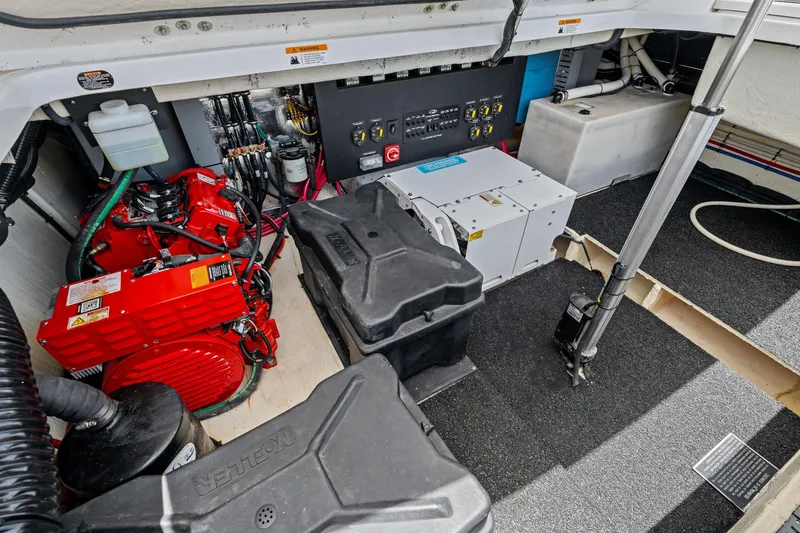 Slide: The Image of Engine compartment of a 2022 Regal boat, featuring red engine and control panel. - 36