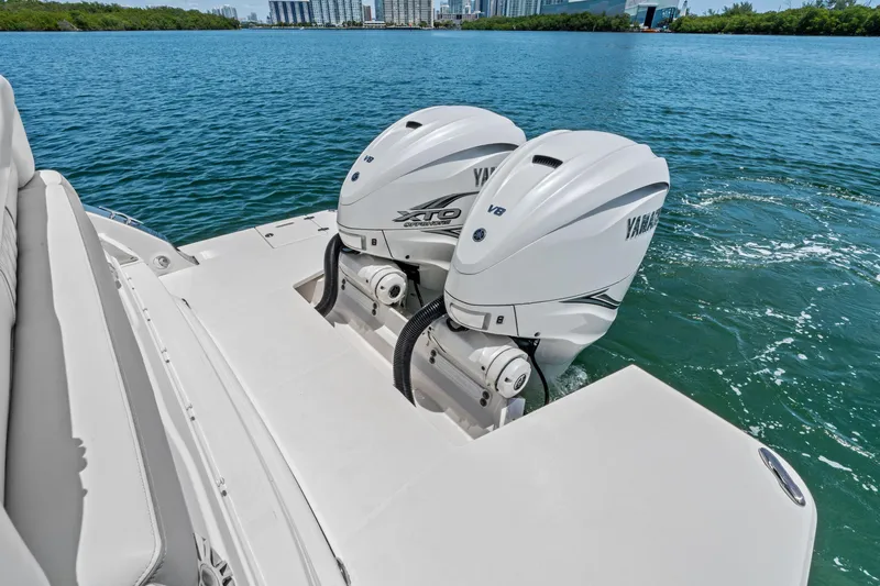 Slide: The Image of 2022 Regal boat with twin Yamaha outboard engines on a calm waterway. - 34
